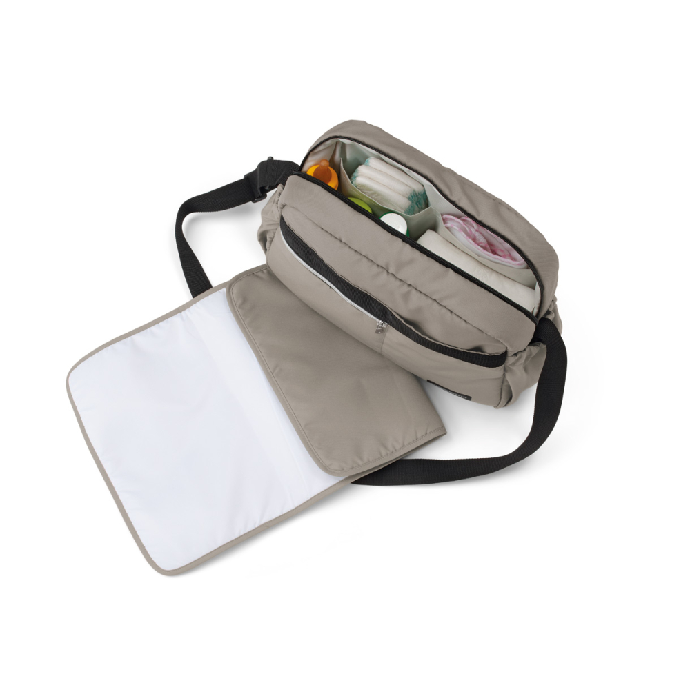 With dedicated pockets and compartments. Changing mat included.